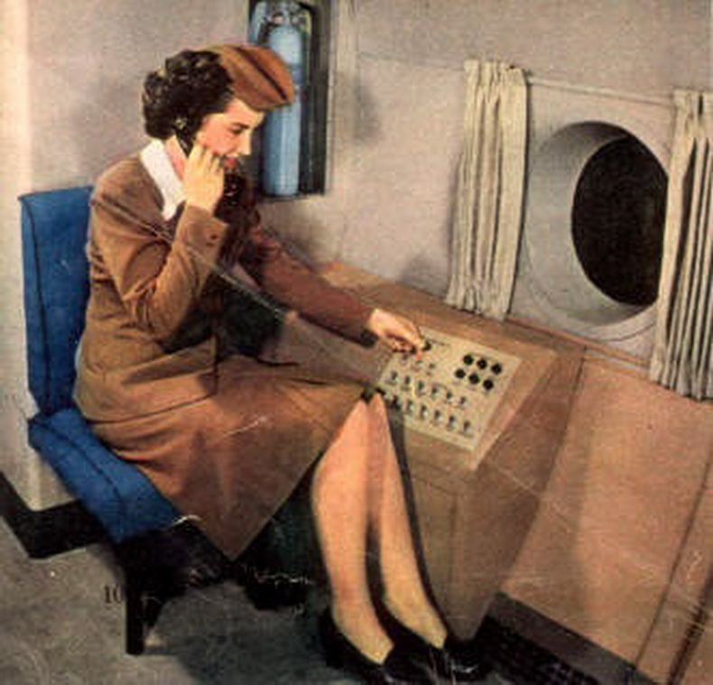 flight attendant using intercom in flight