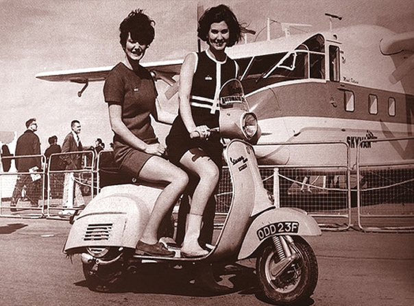 2 stewardess riding a scooter